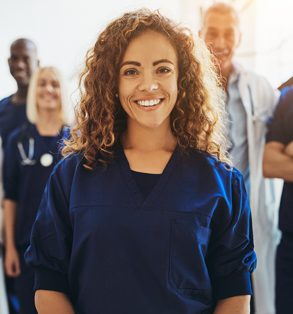 Nurse with Doctors and nurses standing behind